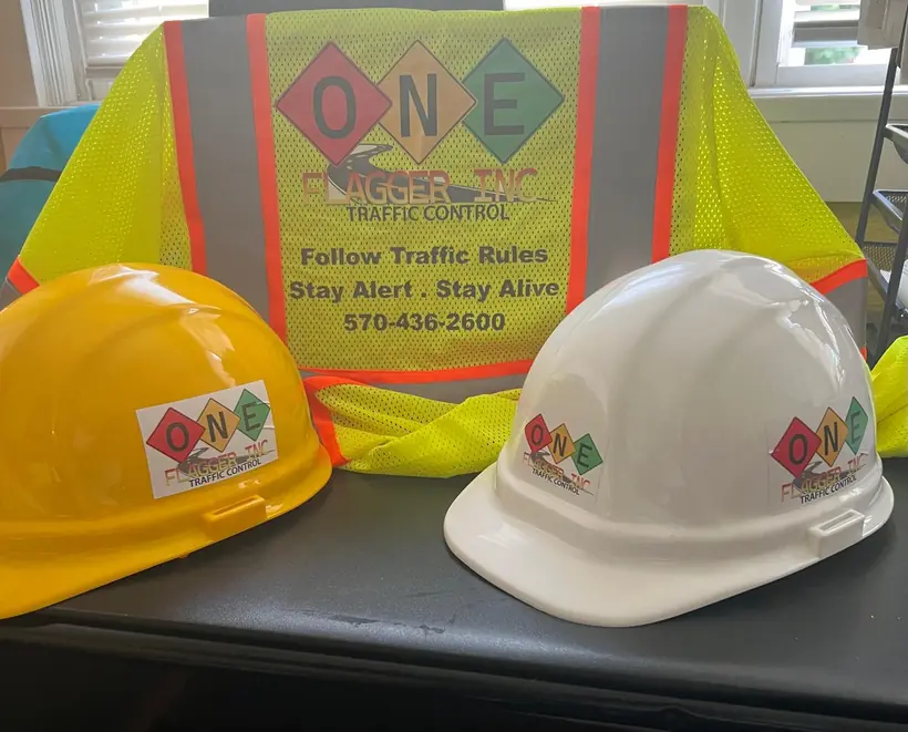 One Flagger Inc branded hardhats and safety vest
