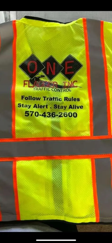 One Flagger Inc safety vest with company logo and slogan